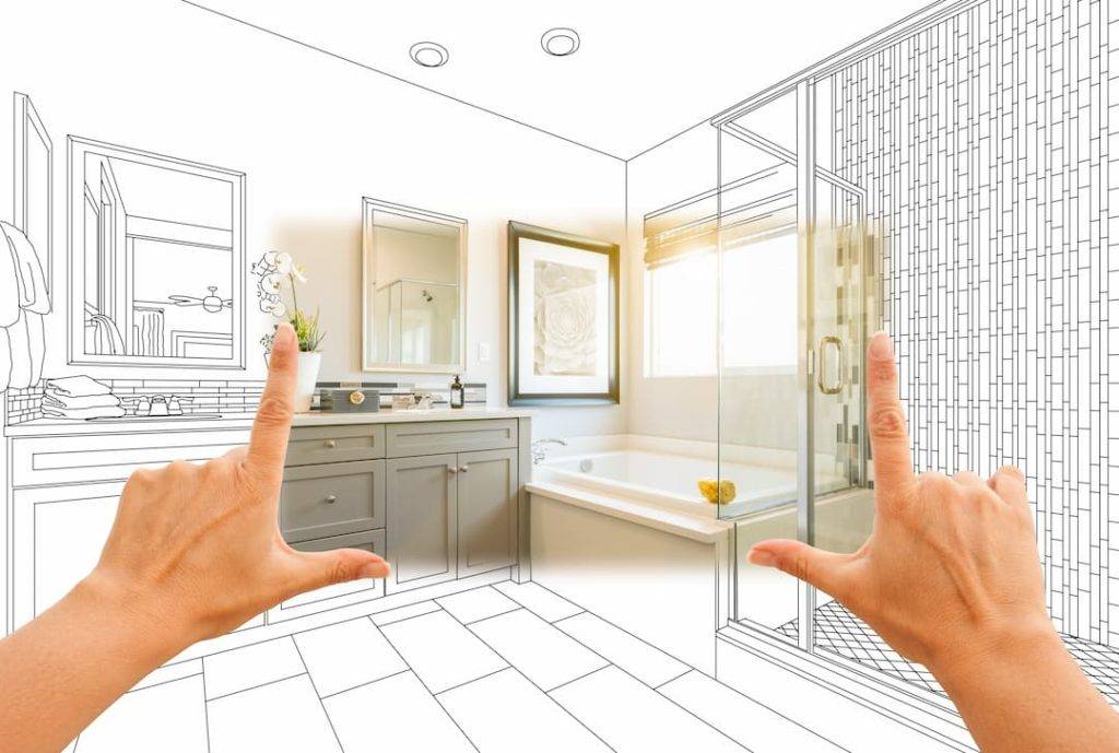 Bathroom design visualisation. Hands framing a bathroom with drawings surrounding